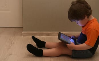IPad Posture for Kids: A boy paying with a tablet